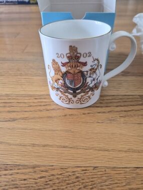 White Porcelain Mug with Gold Trim and Heraldic Crest (2002)